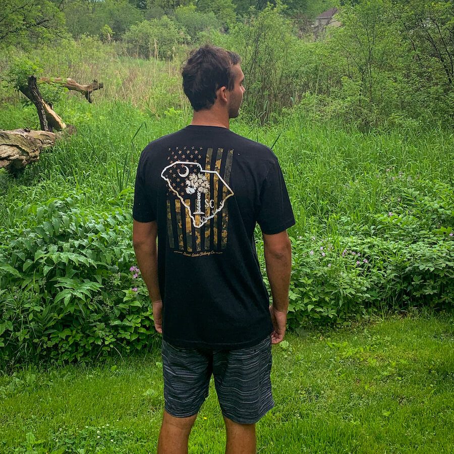 Lifestyle view of a man wearing the shirt near the forest.