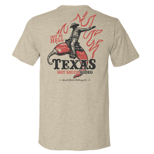 Beige t-shirt with a graphic design of a cowboy riding a pepper and text 'HOT AS HELL - TEXAS HOT SAUCE RODEO'.