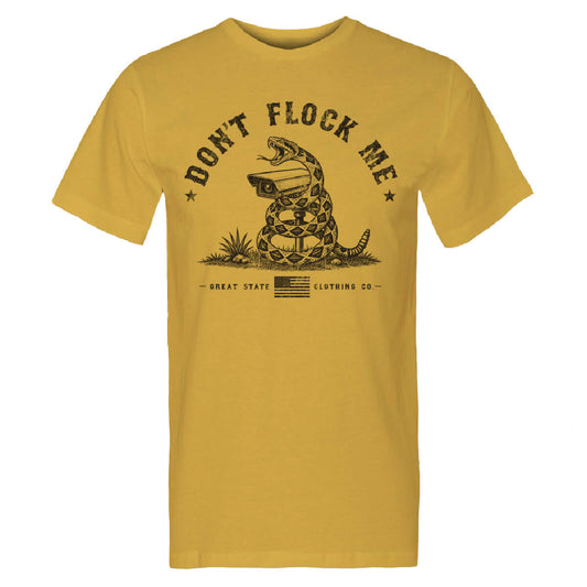 Mustard tee with a graphic of a snake around a surveillance camera with the text 'DONT'T FLOCK ME'.